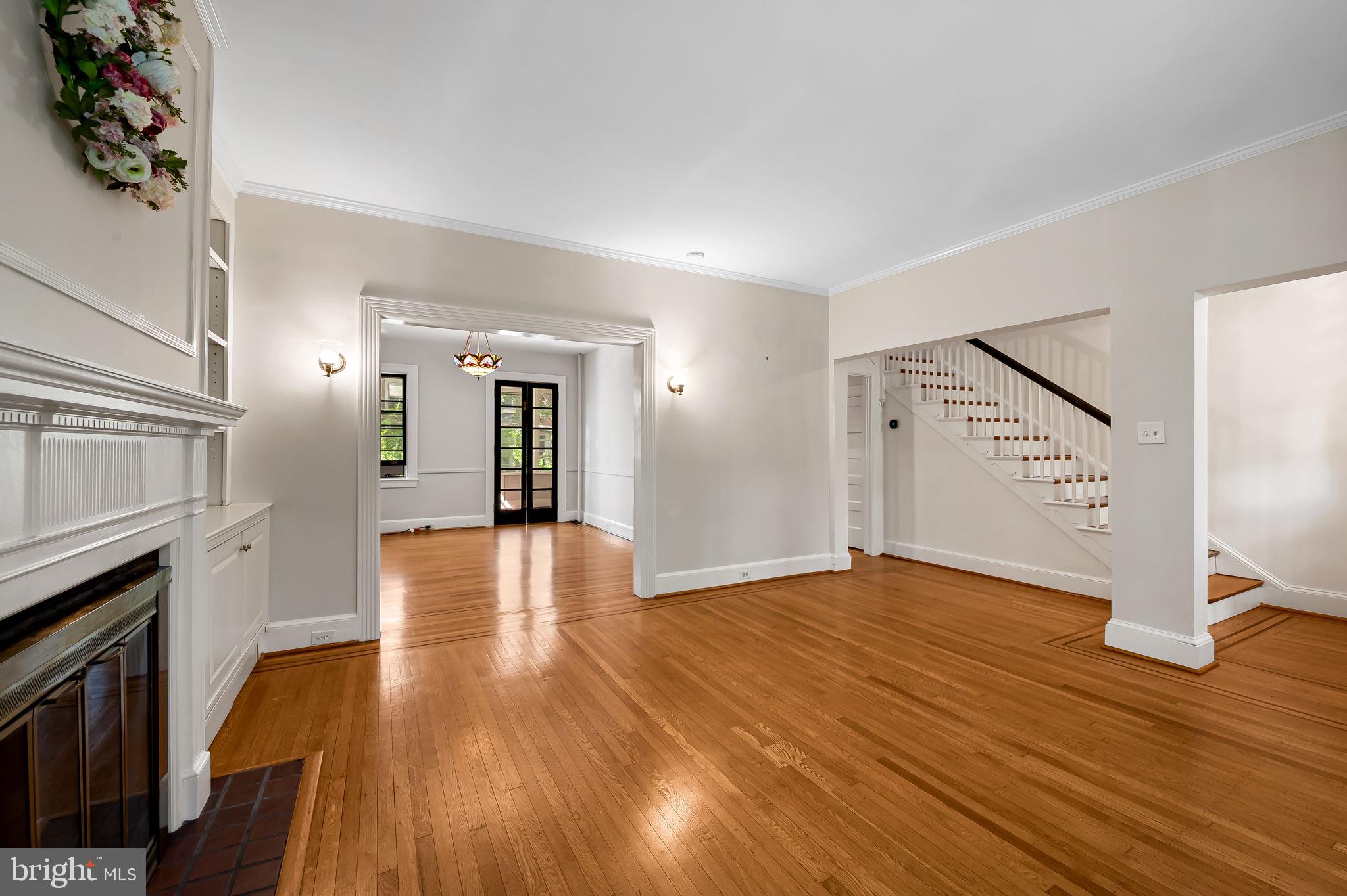 3916 Cloverhill Road Baltimore, MD 21218 - Photo 9 of 47 a view of an empty room with wooden floor and a fireplace