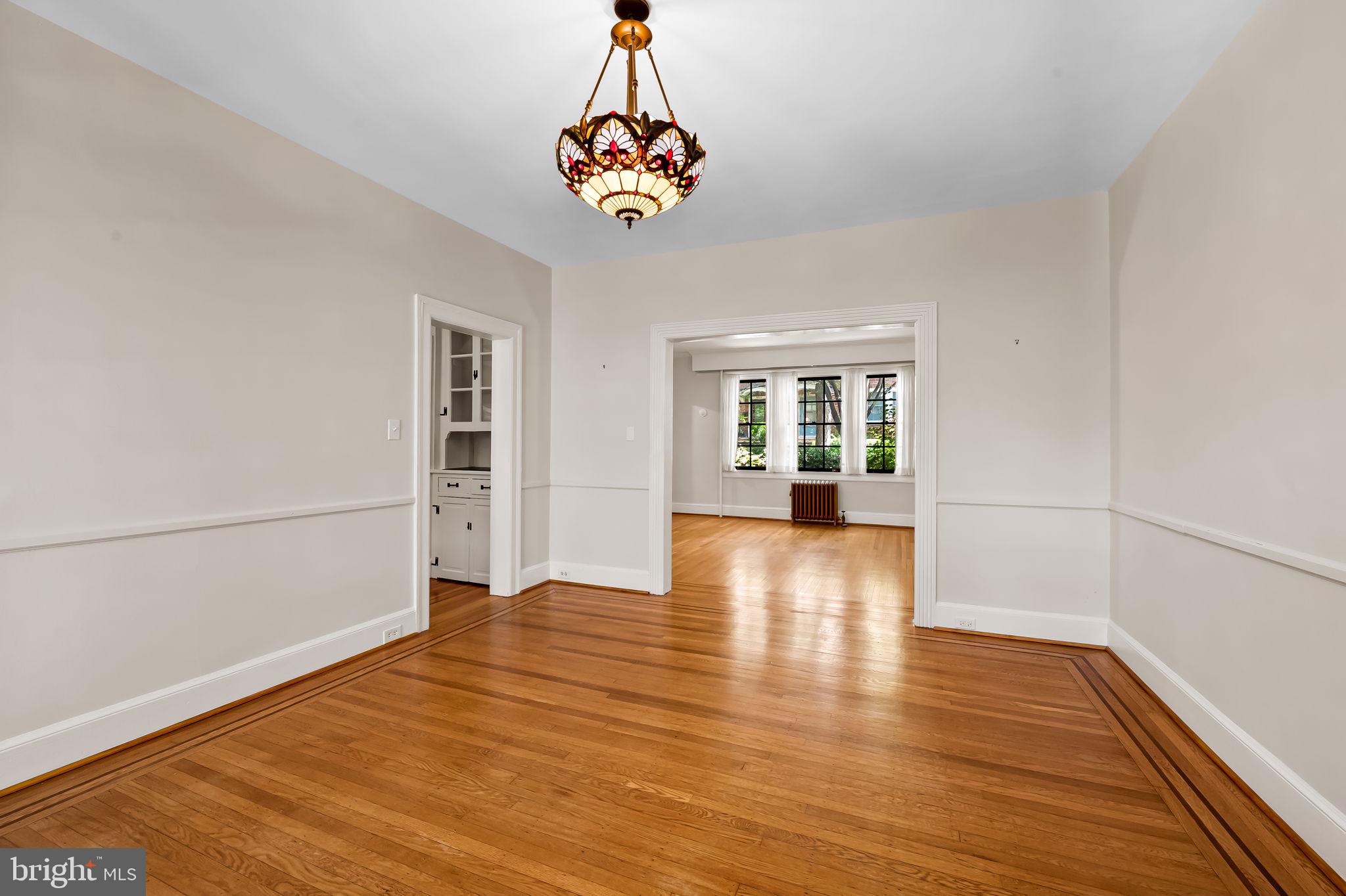 3916 Cloverhill Road Baltimore, MD 21218 - Photo 10 of 47 a view of an empty room with window and wooden floor