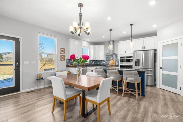 a kitchen with stainless steel appliances granite countertop a sink stove and cabinets