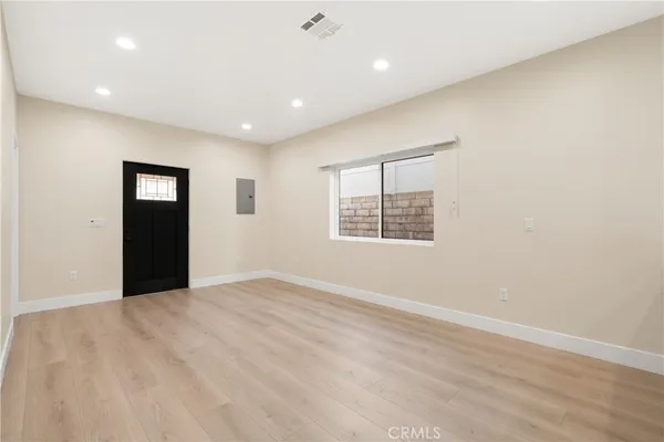 an empty room with windows and closet