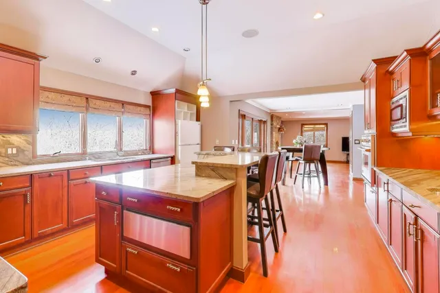 a view of an empty room with furniture and a window