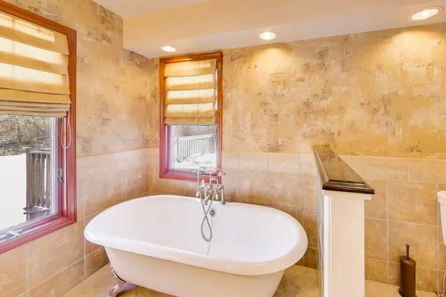 a view of an empty room with a fireplace and a window