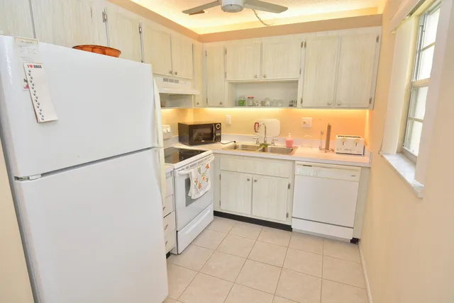 a white refrigerator freezer sitting inside of a kitchen