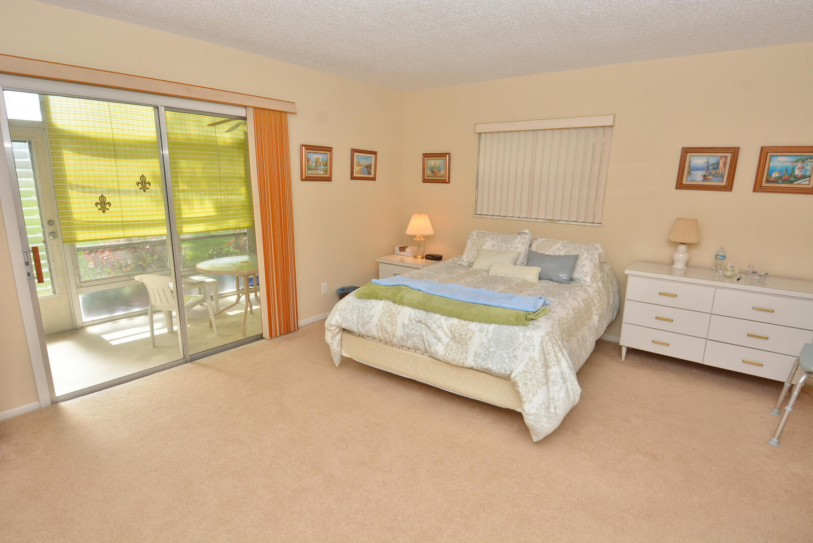 1225 Northwest 21st Street, Unit 2105 Stuart, FL 34994 - Photo 16 of 34 a spacious bedroom with a bed and glass door