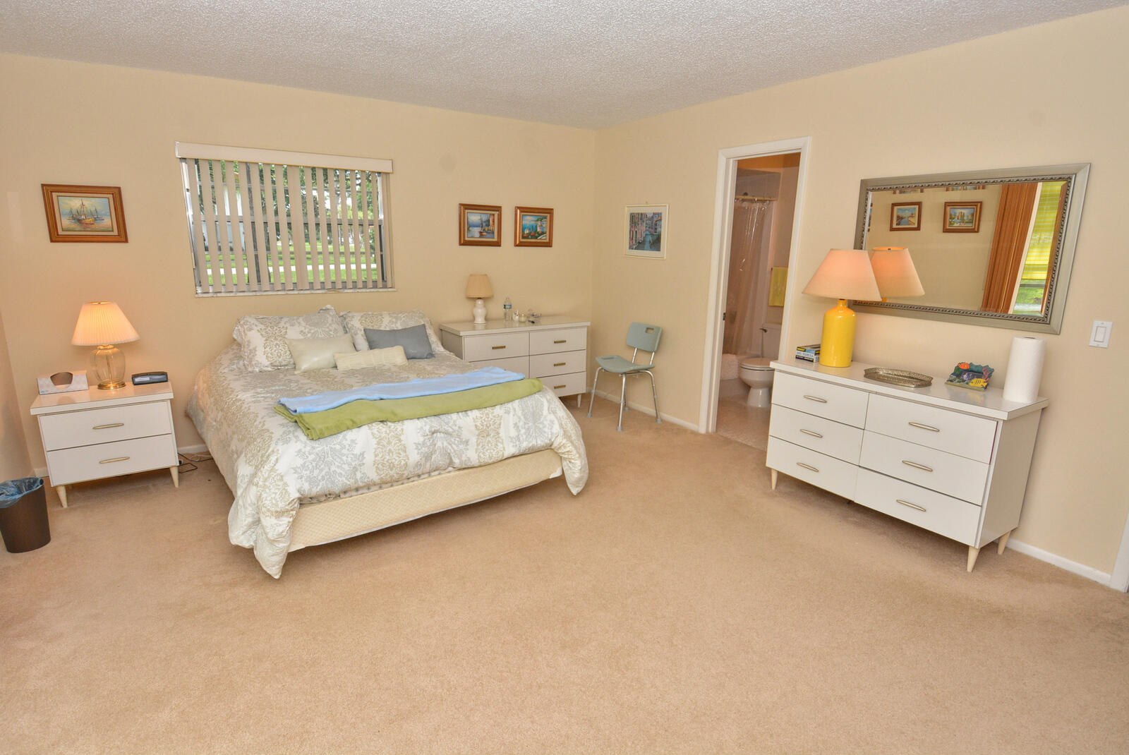 1225 Northwest 21st Street, Unit 2105 Stuart, FL 34994 - Photo 17 of 34 a spacious bedroom with a bed and dresser