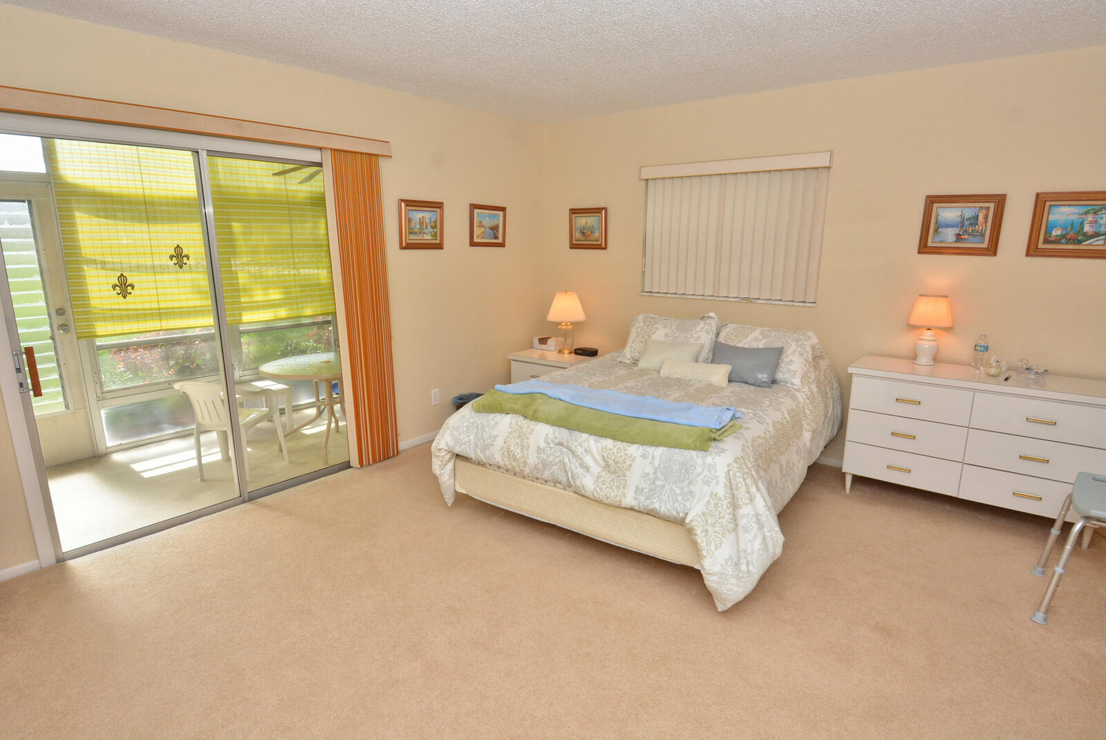 1225 Northwest 21st Street, Unit 2105 Stuart, FL 34994 - Photo 19 of 34 a spacious bedroom with a bed and glass door