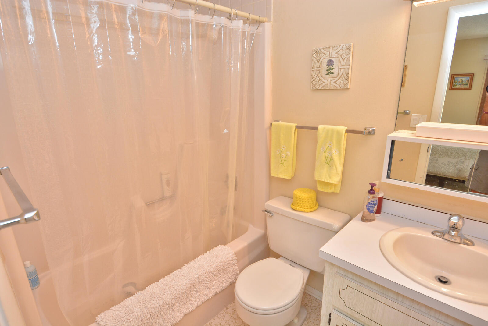 1225 Northwest 21st Street, Unit 2105 Stuart, FL 34994 - Photo 20 of 34 a bathroom with a toilet a sink and a bathtub