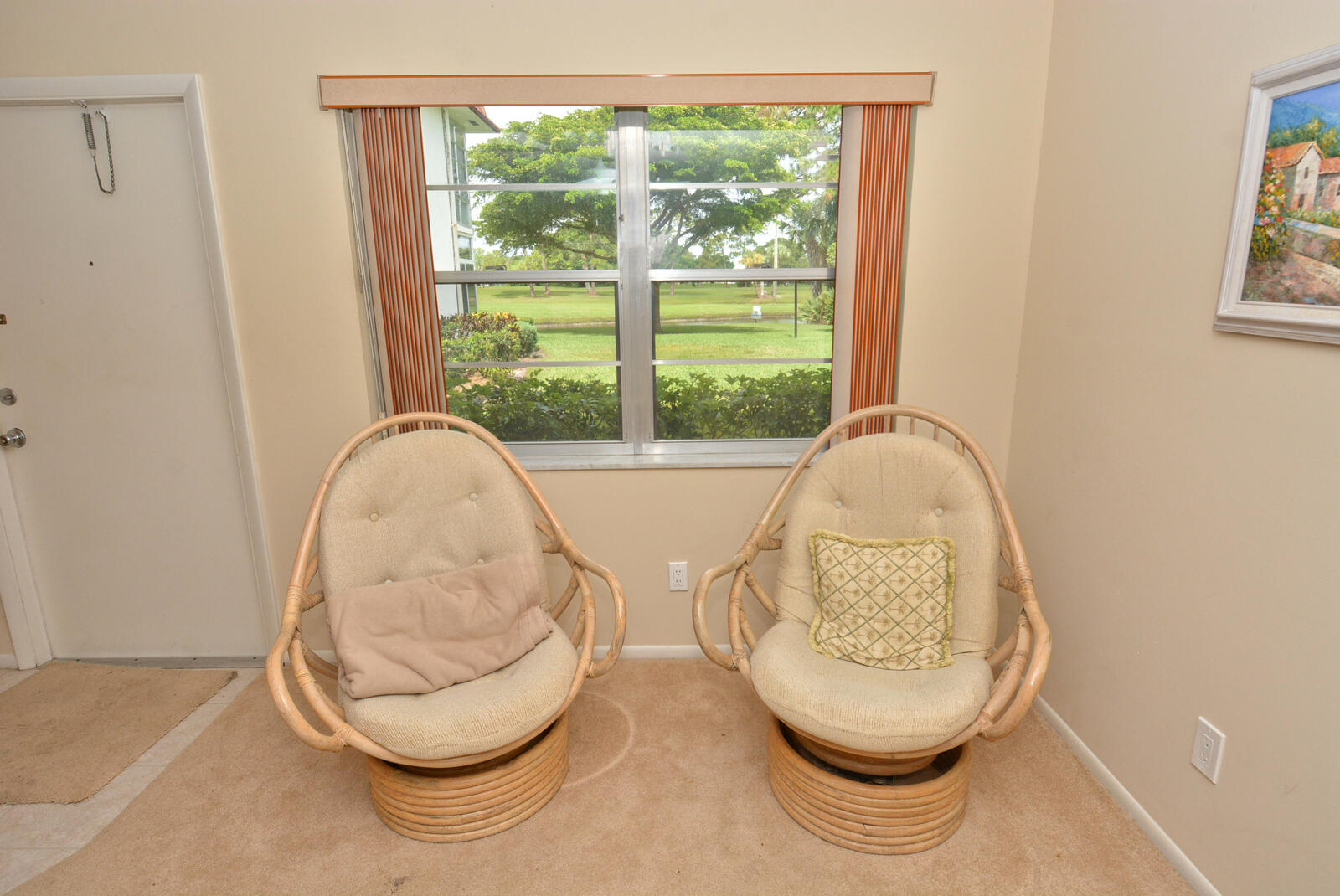 1225 Northwest 21st Street, Unit 2105 Stuart, FL 34994 - Photo 22 of 34 a room with wooden floor and a painting on the wall