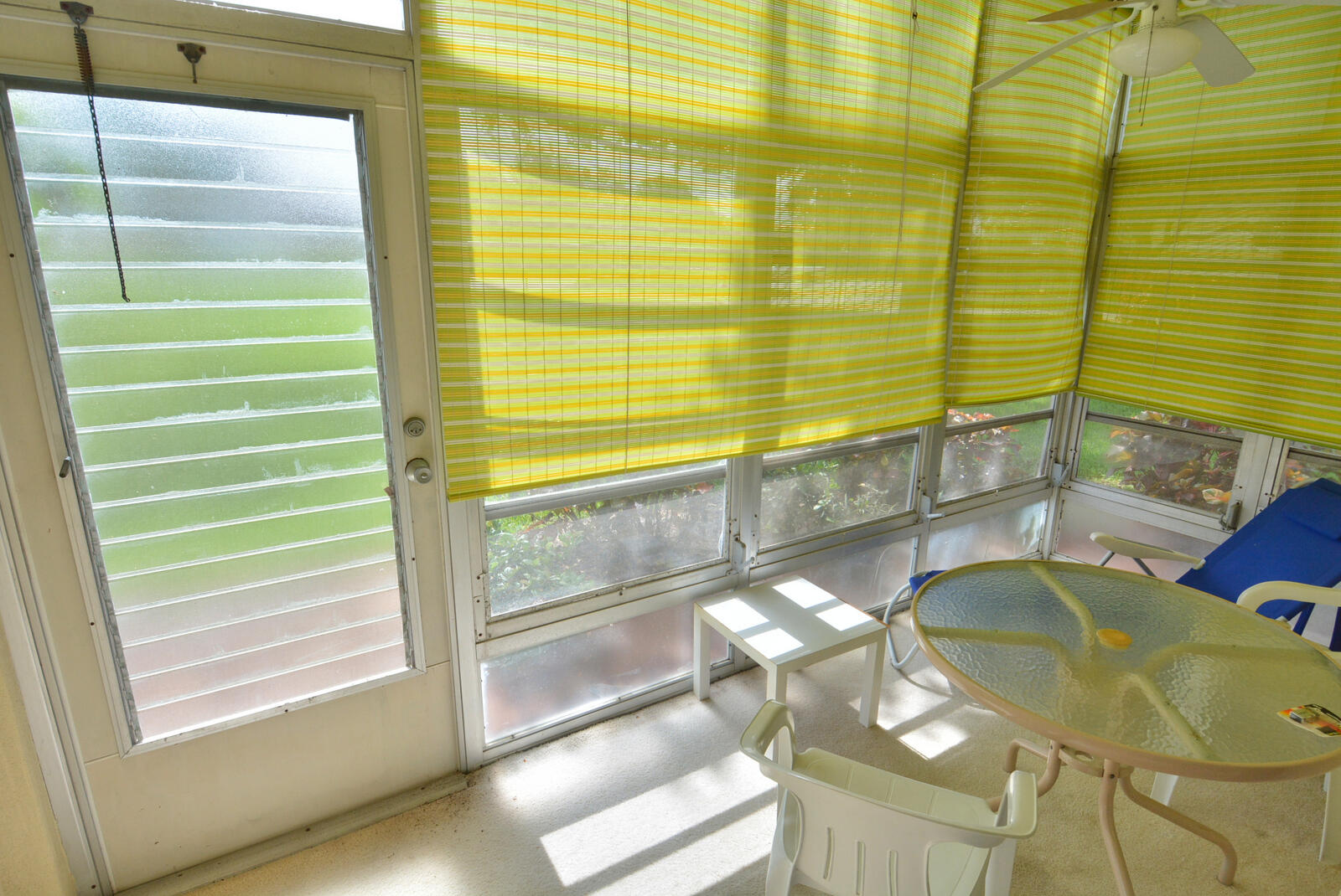 1225 Northwest 21st Street, Unit 2105 Stuart, FL 34994 - Photo 24 of 34 a view of a balcony dining table chairs and a chandelier