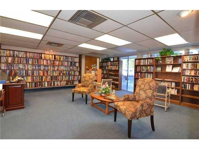 1225 Northwest 21st Street, Unit 2105 Stuart, FL 34994 - Photo 29 of 34 a reading room with furniture and a book shelf