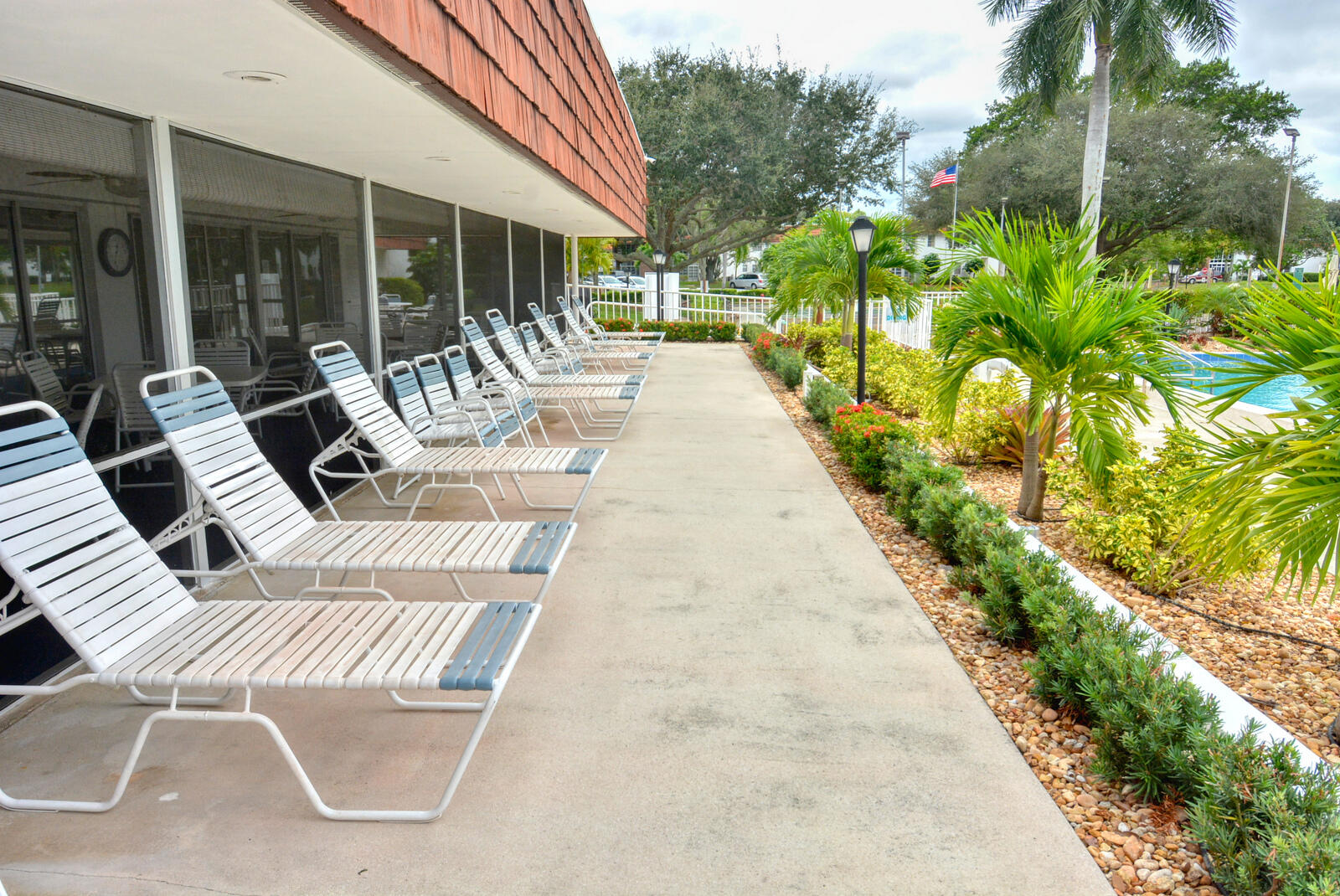 1225 Northwest 21st Street, Unit 2105 Stuart, FL 34994 - Photo 34 of 34 a view of a patio with table and chairs and potted plants