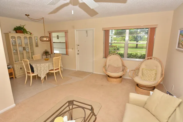 a living room with furniture a window and a chandelier