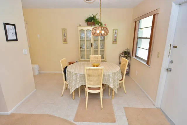 a dining room with furniture a chandelier and wooden floor
