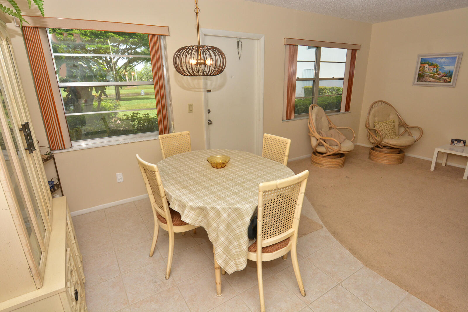 1225 Northwest 21st Street, Unit 2105 Stuart, FL 34994 - Photo 10 of 34 a dining room with furniture a chandelier and wooden floor