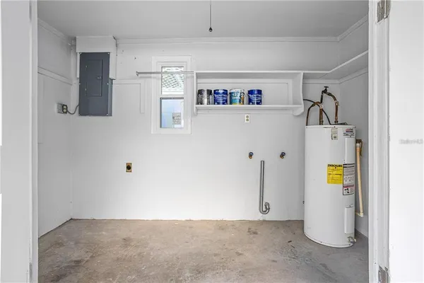 a view of storage and utility room with refrigerator and washer