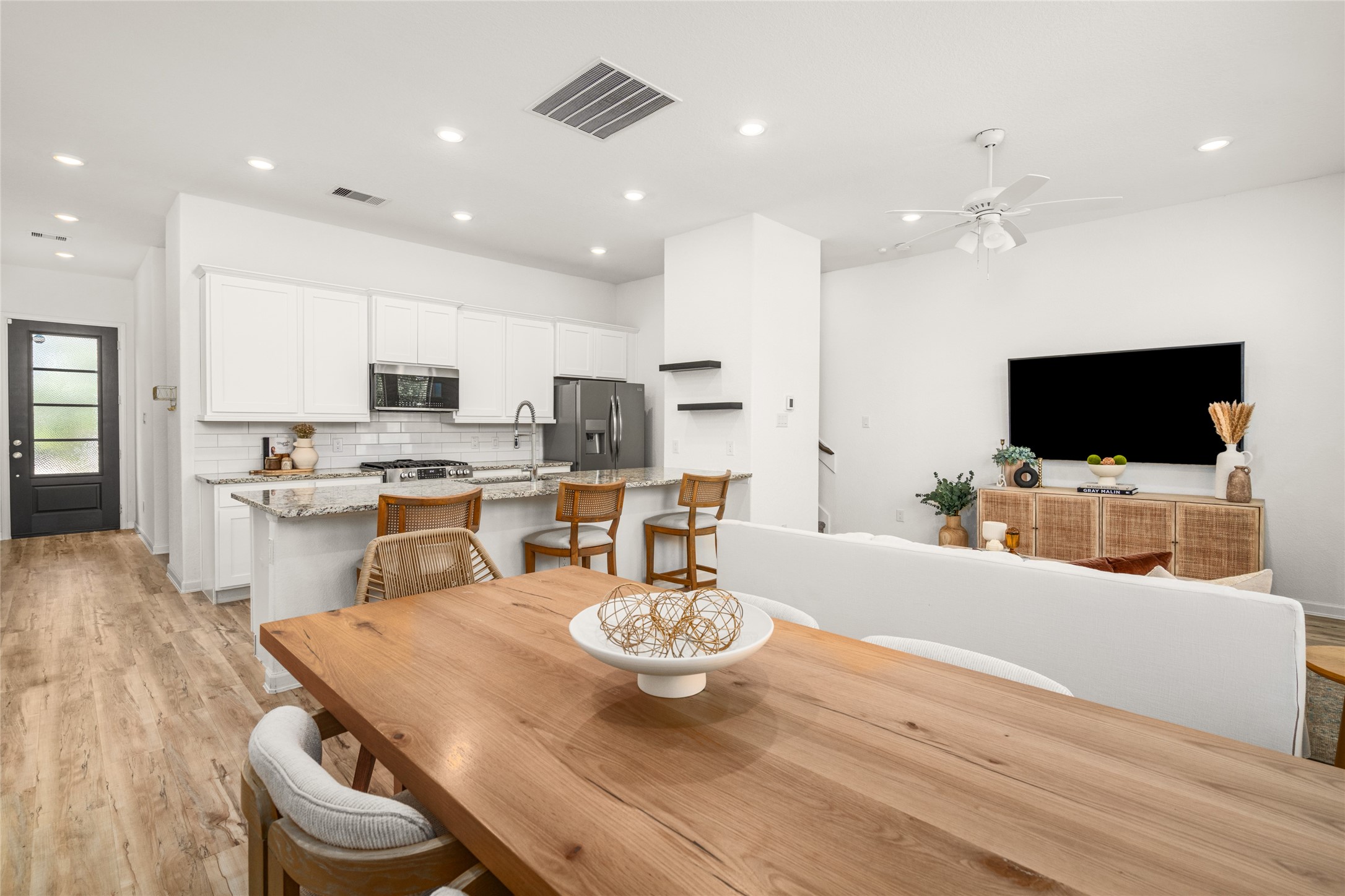 575 Dry Fork Lane Conroe, TX 77304 - Photo 12 of 34 a kitchen with stainless steel appliances kitchen island granite countertop a stove a white table and chairs