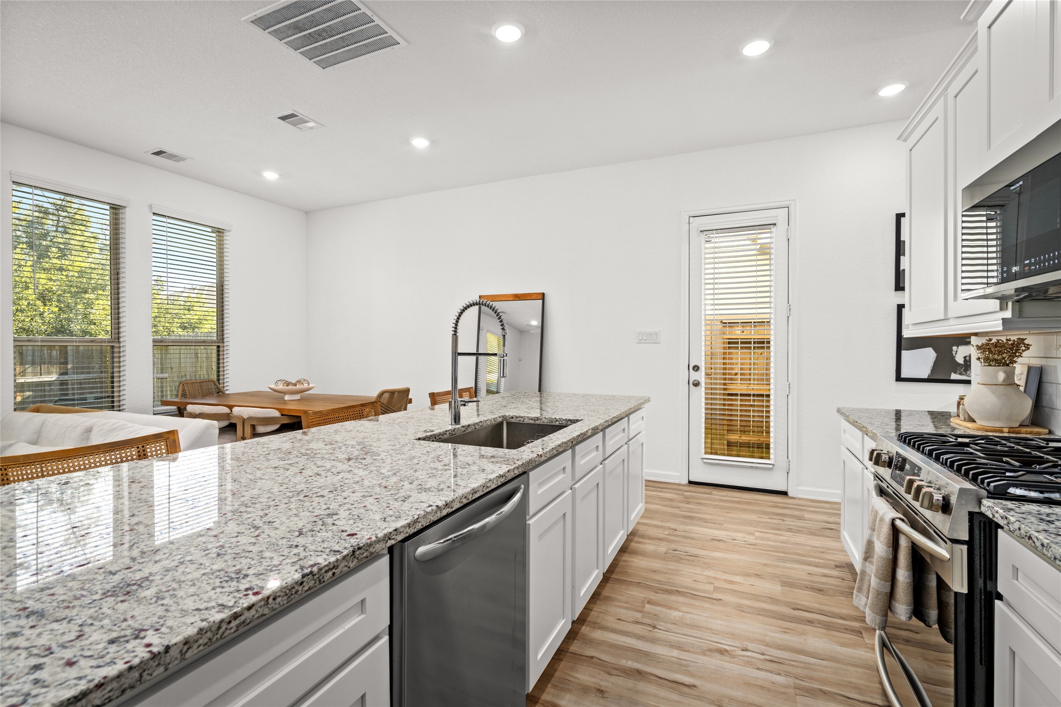 575 Dry Fork Lane Conroe, TX 77304 - Photo 13 of 34 a kitchen with stainless steel appliances granite countertop a sink stove and cabinets