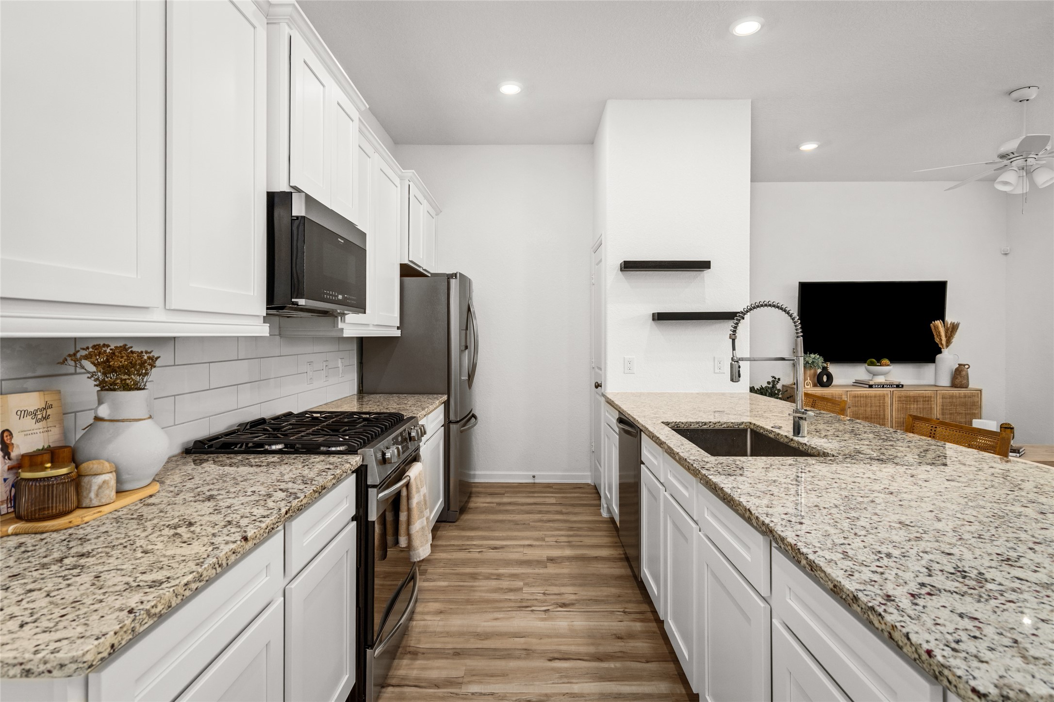 575 Dry Fork Lane Conroe, TX 77304 - Photo 6 of 34 a kitchen with granite countertop a sink and steel appliances