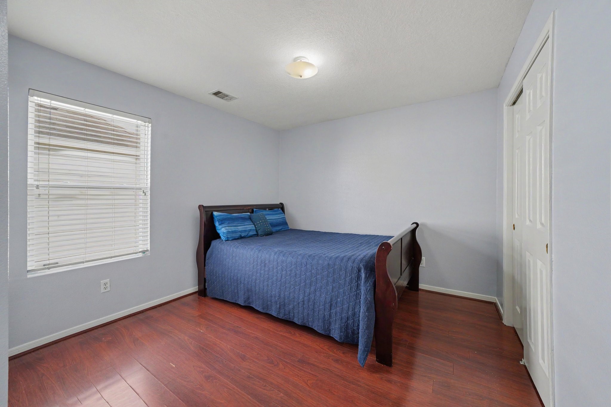 5622 Wasabi Lane Baytown, TX 77521 - Photo 20 of 29 a bedroom with a bed and wooden floor