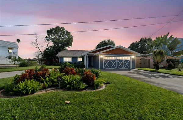 a kitchen with kitchen island granite countertop a sink cabinets stainless steel appliances and a counter top space