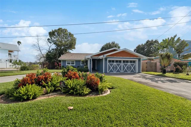 a kitchen with cabinets stainless steel appliances and wooden floor