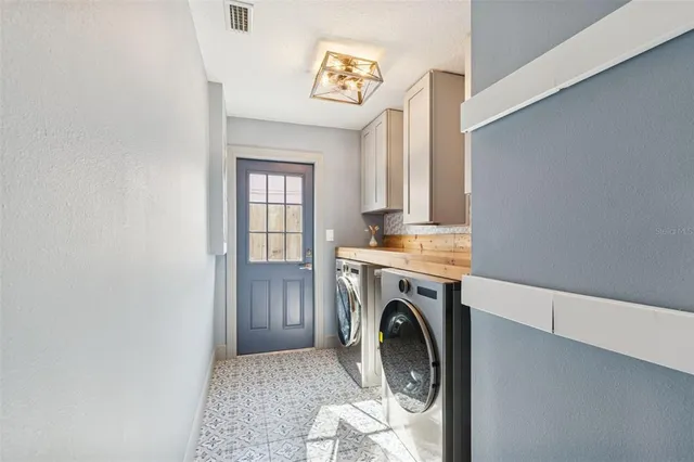 a view of a hallway with wooden floor and a bathroom