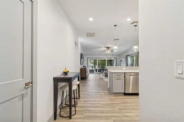 a living room with furniture a flat screen tv and a lamp
