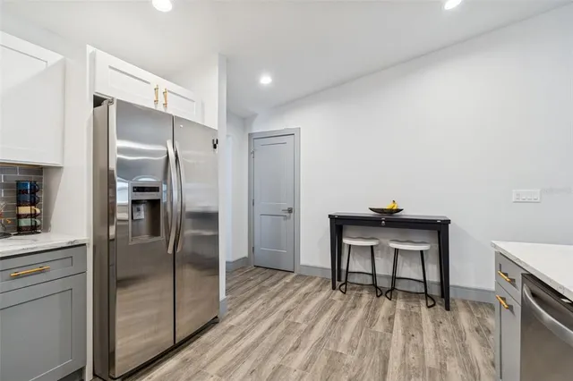 a bathroom with a granite countertop sink a toilet and bathtub