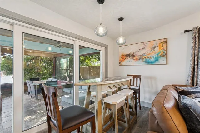 a view of a dining table and chairs in patio with wooden fence