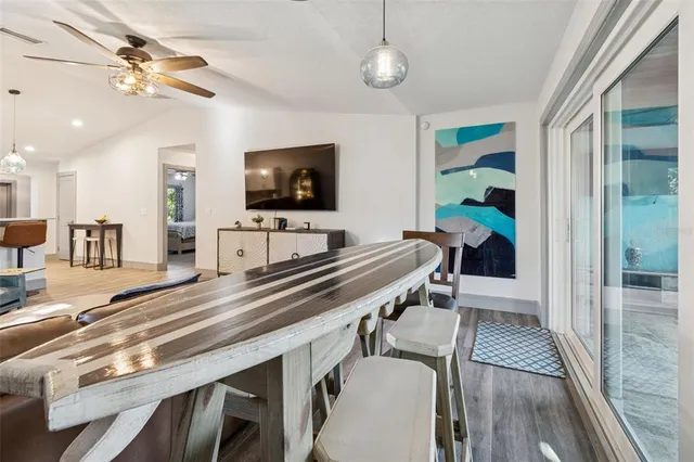 a view of an empty room with furniture and a window