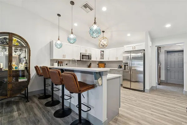 a living room with furniture and floor to ceiling windows