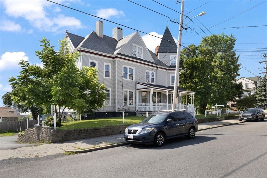 311 Elm Street Woonsocket, RI 02895 - Photo 2 of 29 a car parked in front of a white house