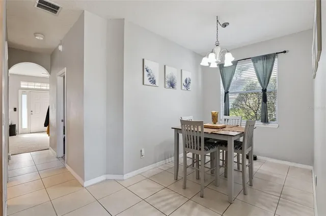 a view of a dining room with furniture and chandelier