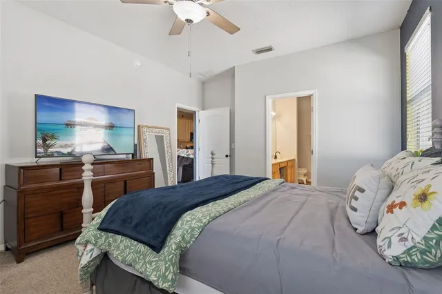 a bedroom with a bed and a dresser in it