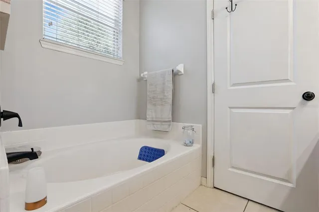 a bathroom with a tub and a shower
