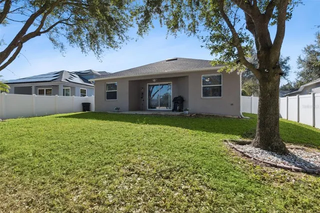 a front view of a house with a garden and yard