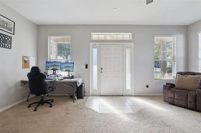 a view of a livingroom with workspace and a window