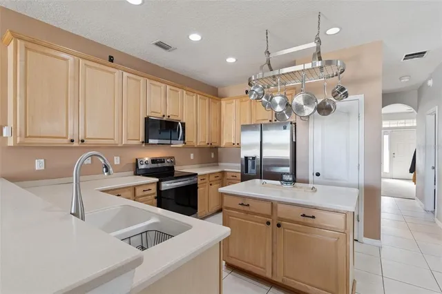 a kitchen with a sink appliances and cabinets