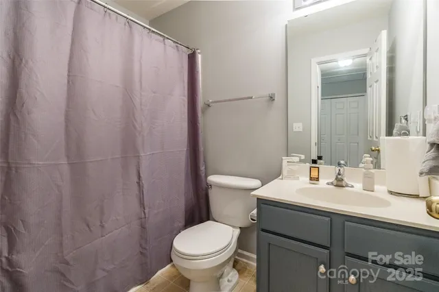 a bathroom with a sink toilet and a mirror