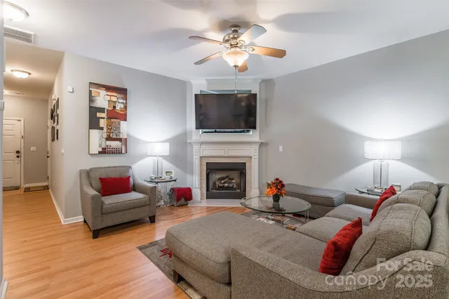 a living room with furniture fireplace and flat screen tv