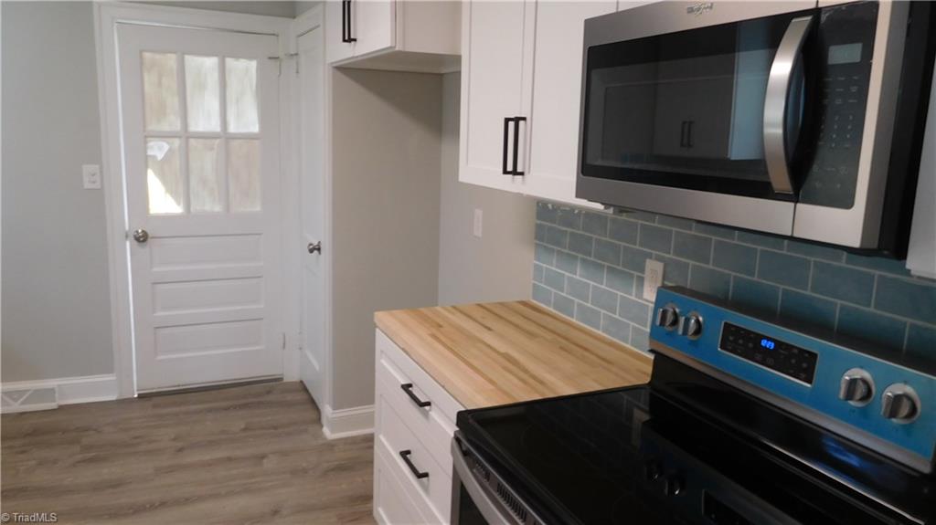724 Sain Road Mocksville, NC 27028 - Photo 10 of 21 Pantry perfect for additional storage. Vinyl plank flooring in Kitchen.