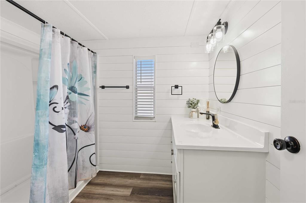 5408 Dean Dairy Road Zephyrhills, FL 33541 - Photo 16 of 62 a bathroom with a sink a mirror a vanity and shower