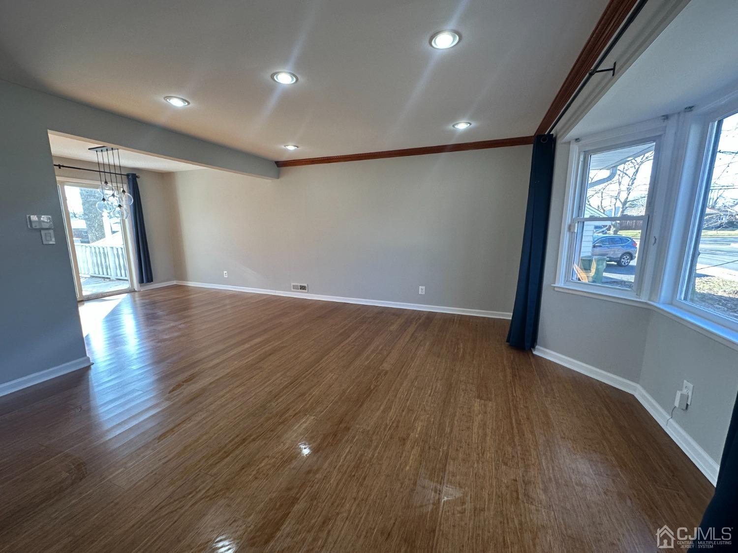 3 Hill Road Edison, NJ 08817 - Photo 4 of 27 an empty room with wooden floor and windows