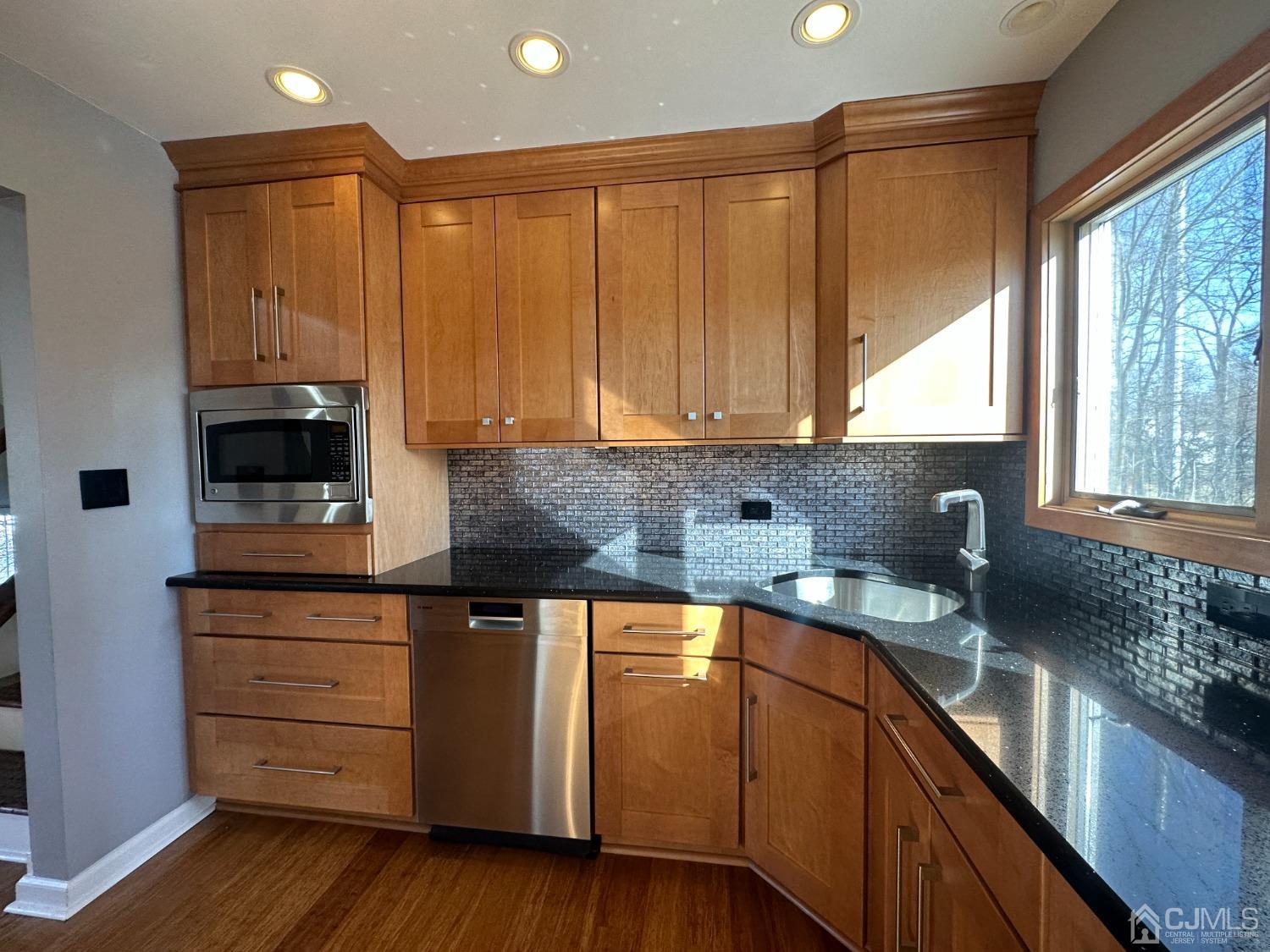 3 Hill Road Edison, NJ 08817 - Photo 9 of 27 a kitchen with granite countertop wooden cabinets and white appliances
