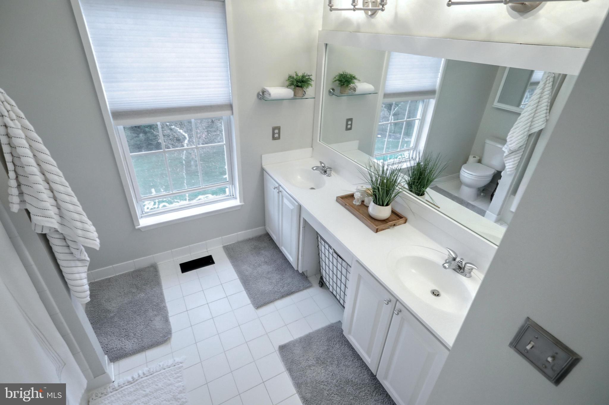 48 Smith Mill Road New Freedom, PA 17349 - Photo 30 of 40 Main bath, double sinks, tile floor, framed mirror