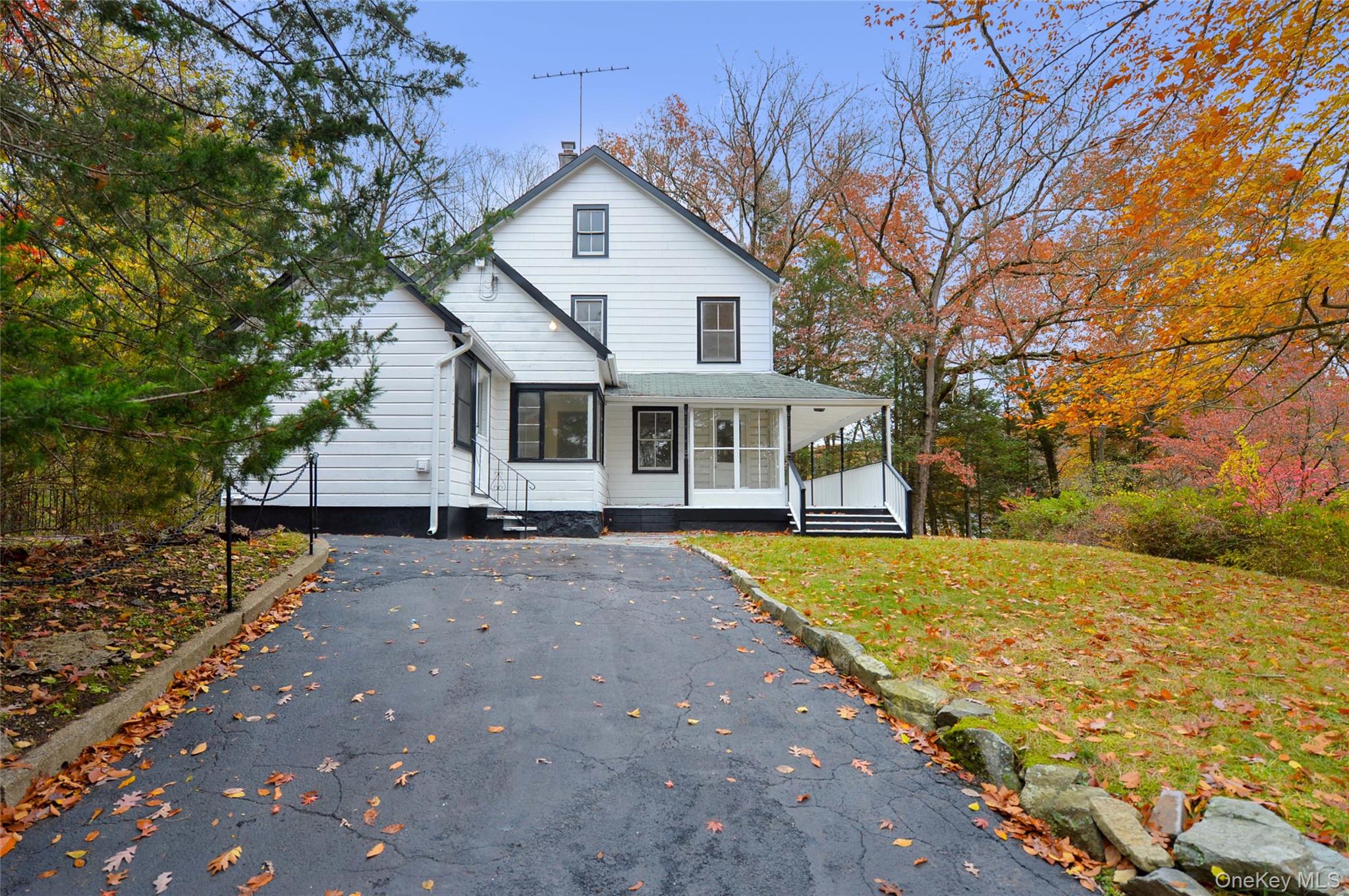 19 Johnsontown Road Sloatsburg, NY 10974 - Photo 5 of 41 View of front of house featuring driveway, a chimney, covered porch, and a front yard