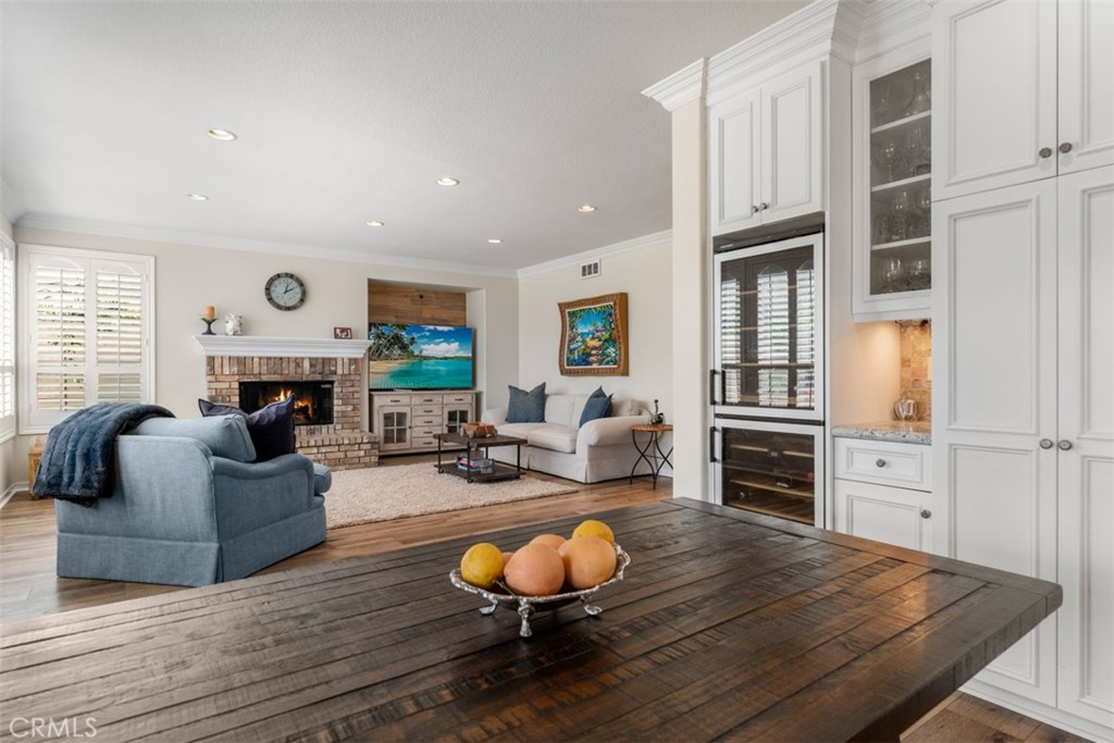 124 Nighthawk Irvine, CA 92604 - Photo 13 of 61 a living room with furniture kitchen view and a wooden floor