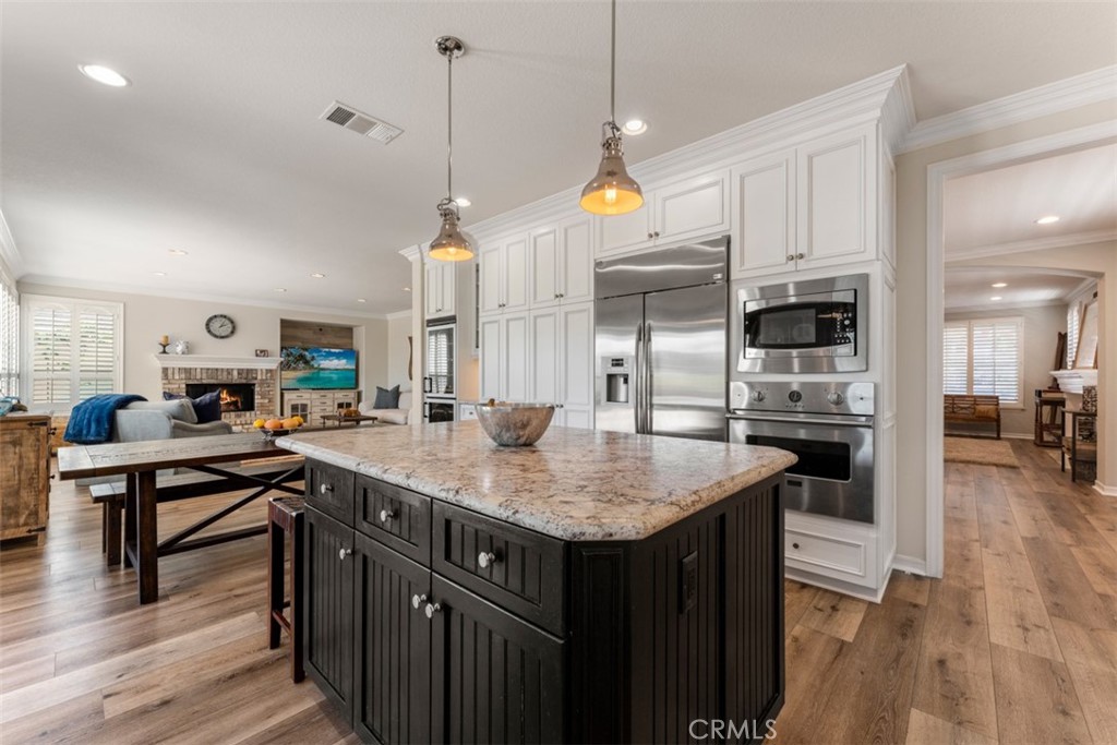 124 Nighthawk Irvine, CA 92604 - Photo 19 of 61 a kitchen with stainless steel appliances granite countertop a sink a stove and a wooden floor