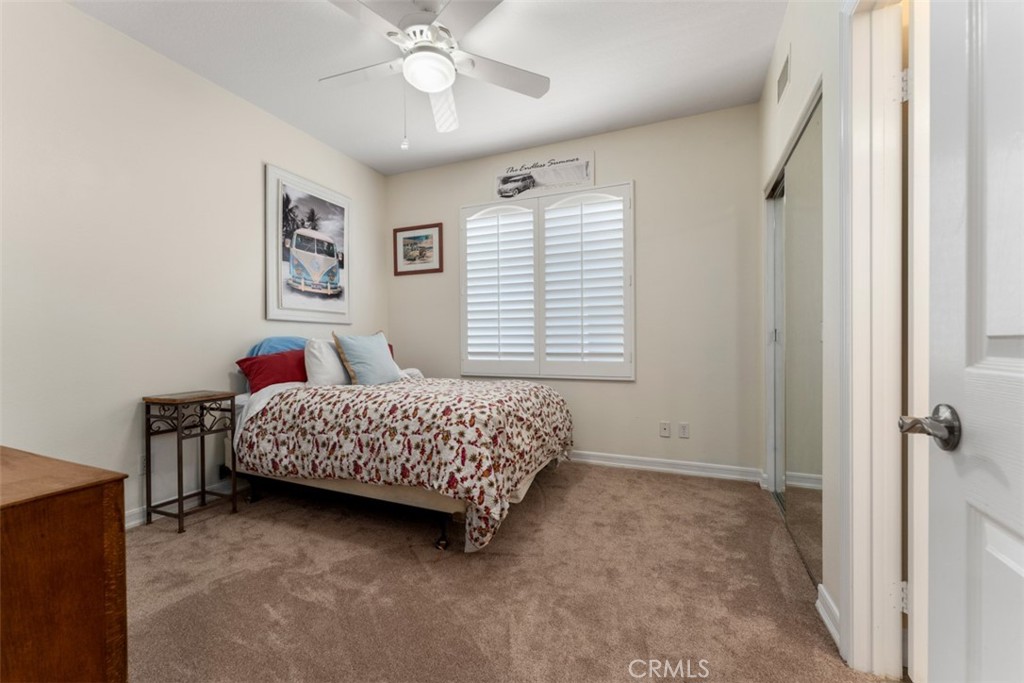 124 Nighthawk Irvine, CA 92604 - Photo 27 of 61 a bedroom with a bed and a chandelier