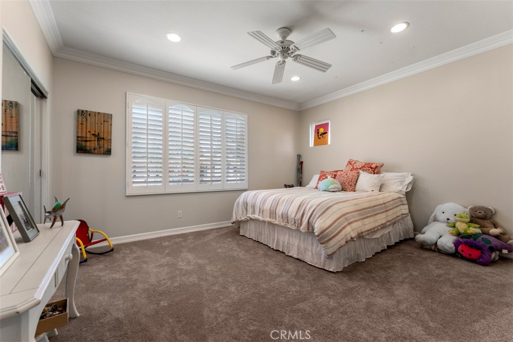 124 Nighthawk Irvine, CA 92604 - Photo 31 of 61 a spacious bedroom with a bed and a chandelier